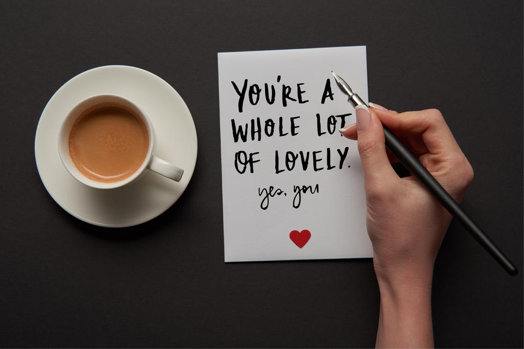 vágott nézet nő üdvözlőlap írása "egy csomó szép, igen" felirat, piros szív jel közelében csésze kávé - Fotó, kép