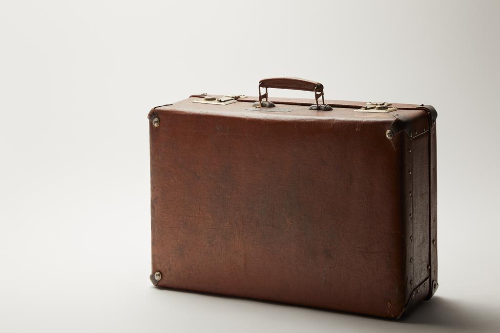 retro leather brown suitcase on grey background  - Photo, Image