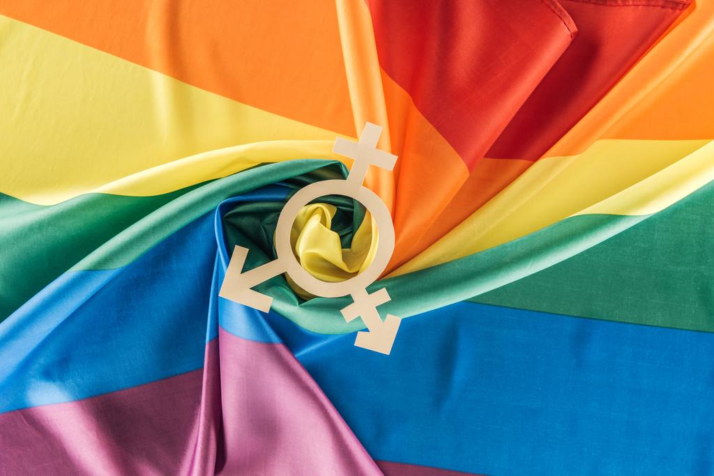 top view of rainbow flag creased in spiral shape with gender sign, lgbt concept - Photo, Image