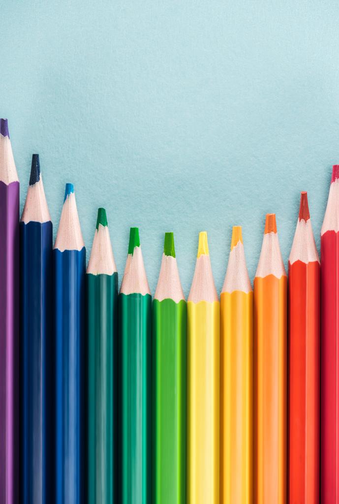 top view of rainbow multicolored pencils on blue background, lgbt concept - Photo, Image