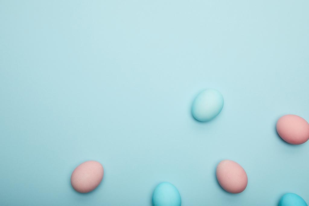 Верхний вид пасхальных яиц на голубом фоне
 - Фото, изображение