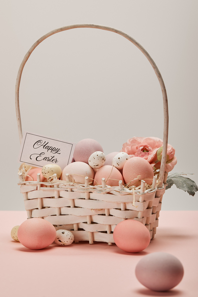 easter chicken and quail eggs in straw basket with flower and card with happy easter lettering - Photo, Image