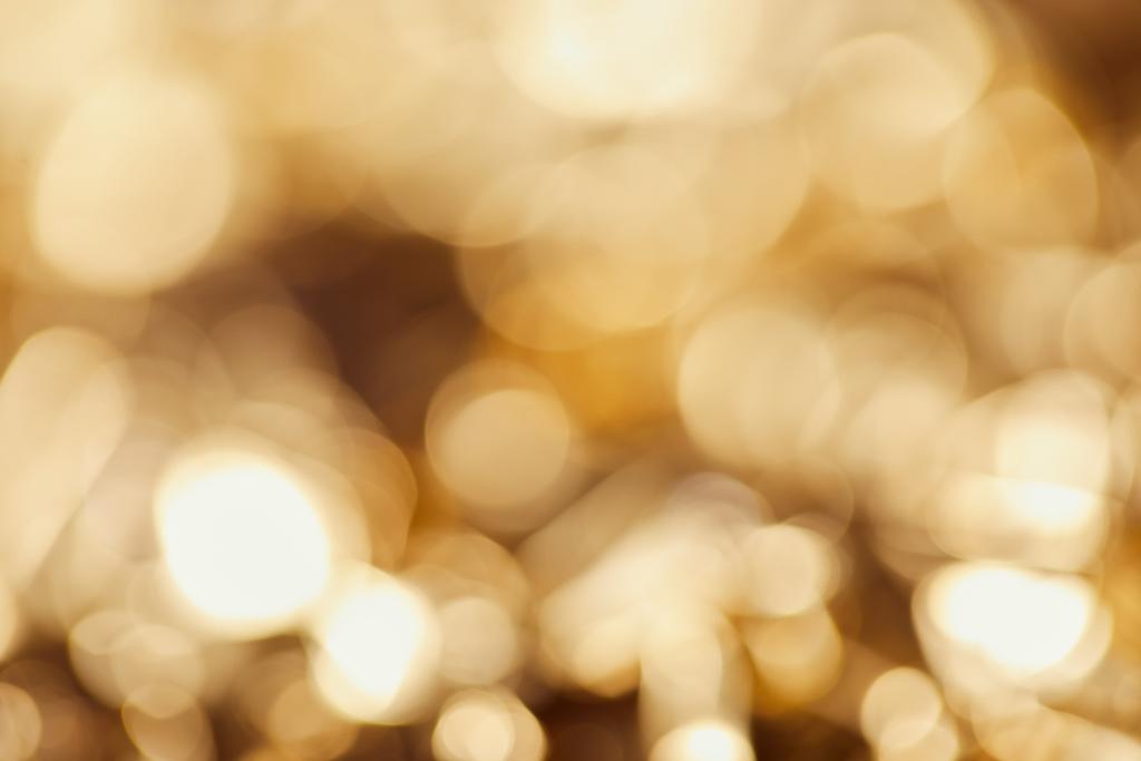 heldere wazig twinkles met gouden fonkelende lampjes - Foto, afbeelding