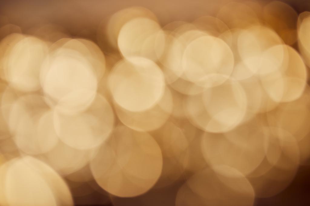 Rozmazané zlaté jiskry na tmavém pozadí - Fotografie, Obrázek