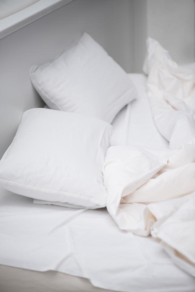 selective focus of bedroom with white pillows and blanket on bed - Photo, Image