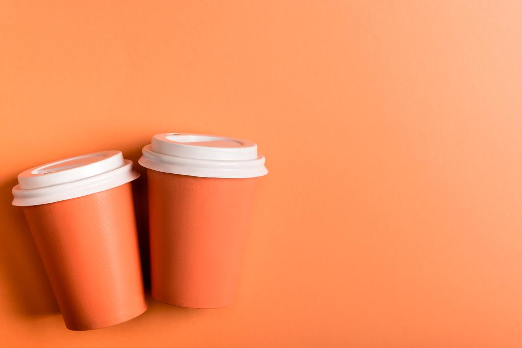 disposable cups on coral background, color of 2019 concept - Photo, Image