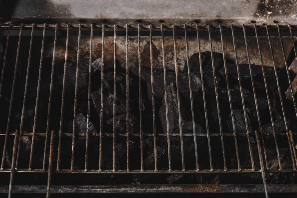 dark black natural coals under iron bbq grid - Photo, Image