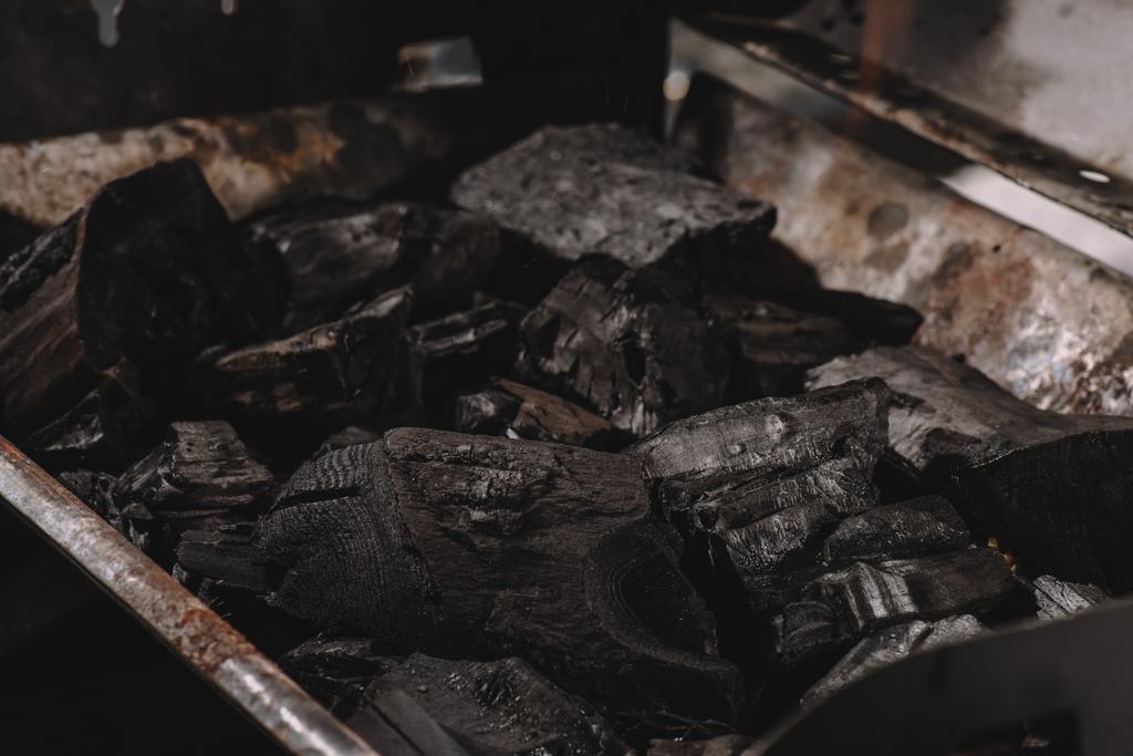 pile de charbons noirs foncés dans un barbecue en fer
  - Photo, image