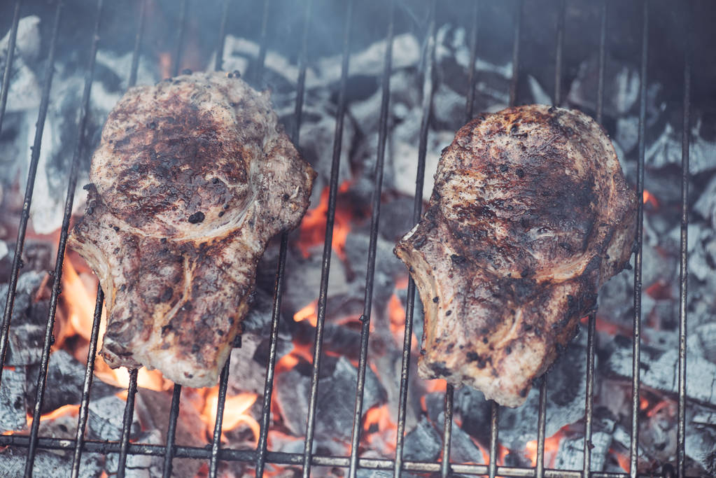 juicy tasty steaks grilling on barbecue grill grade with smoke - Photo, Image
