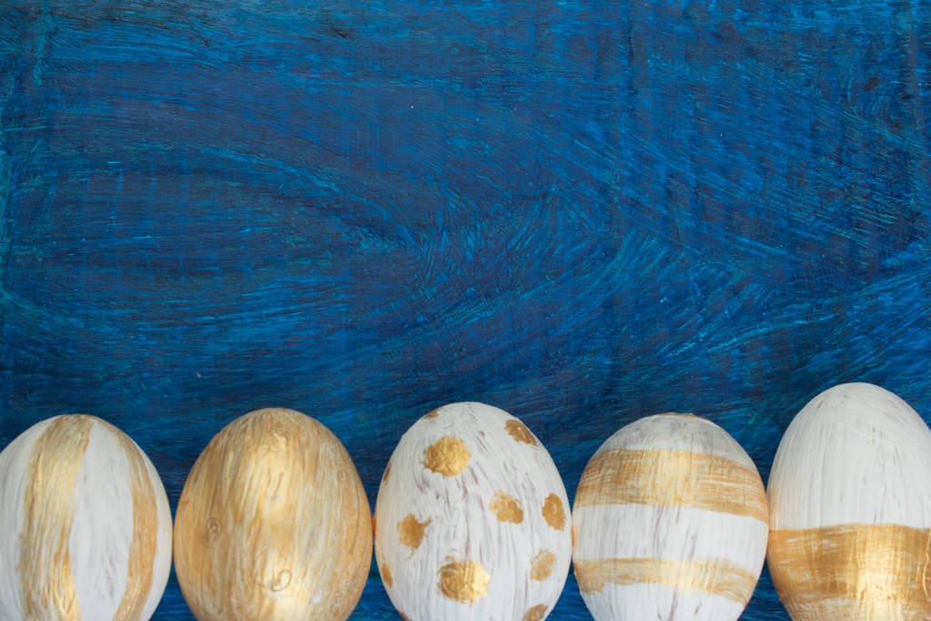 Happy Easter. Painted eggs on wooden table. Top view. Copy space for text - Photo, Image