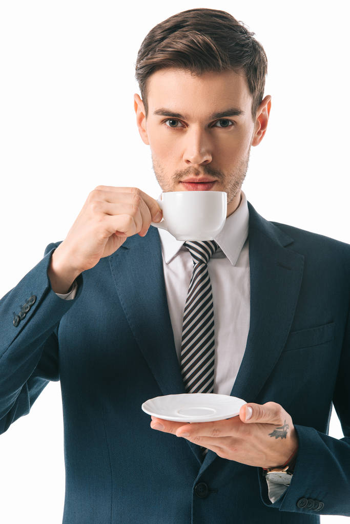 handsome businessman holding cup of coffee isolated on white - Photo, Image