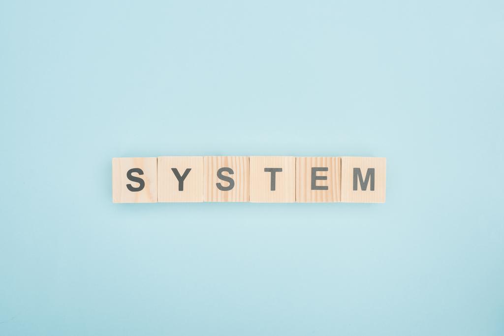 top view of system lettering made of wooden cubes on blue background - Photo, Image