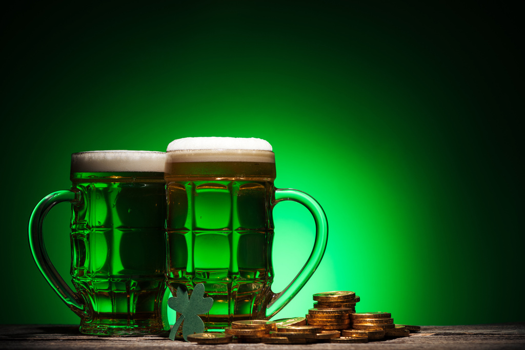 glasses of irish beer near golden coins on st patricks day on green background - Photo, Image