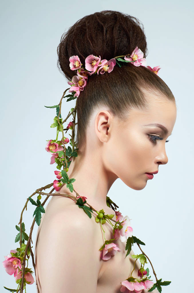 beautiful woman in flowers. model girl with make-up and hairstyle. spring lady plant - Photo, Image