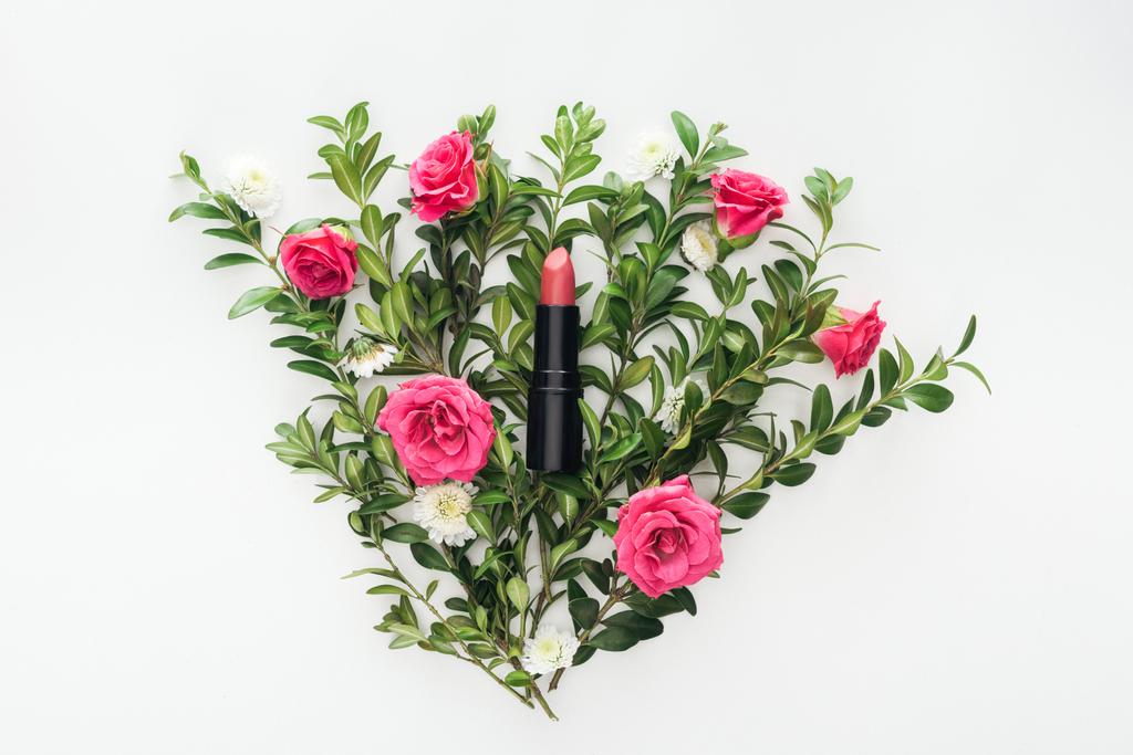 top view of lipstick on flowers composition on white background - Photo, Image