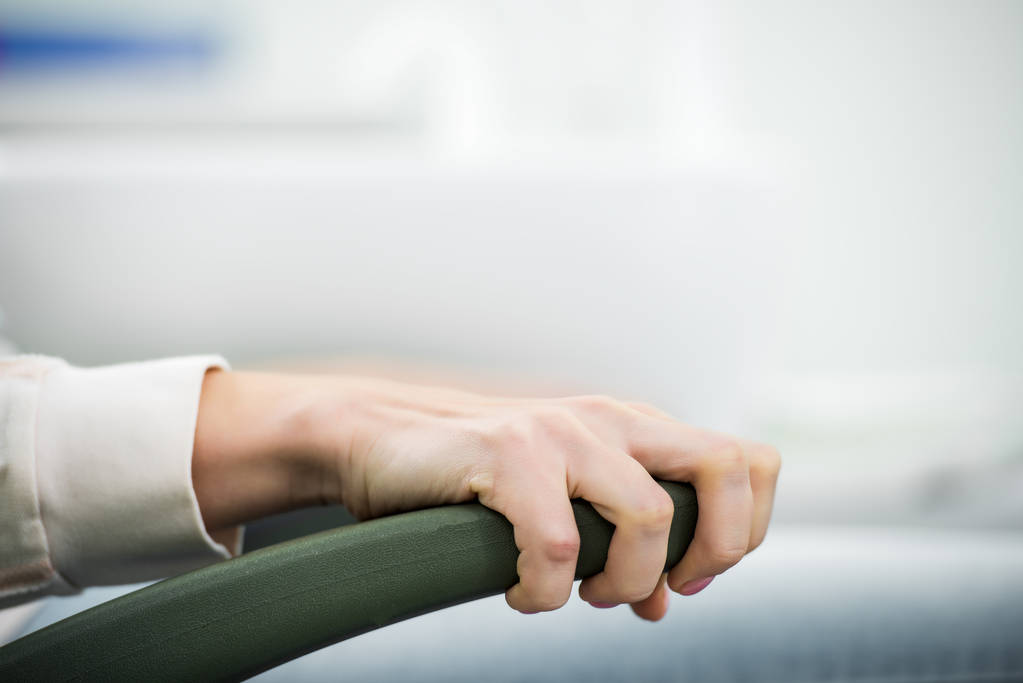 cropped view of woman holding chair handle in dental clinic - Photo, Image