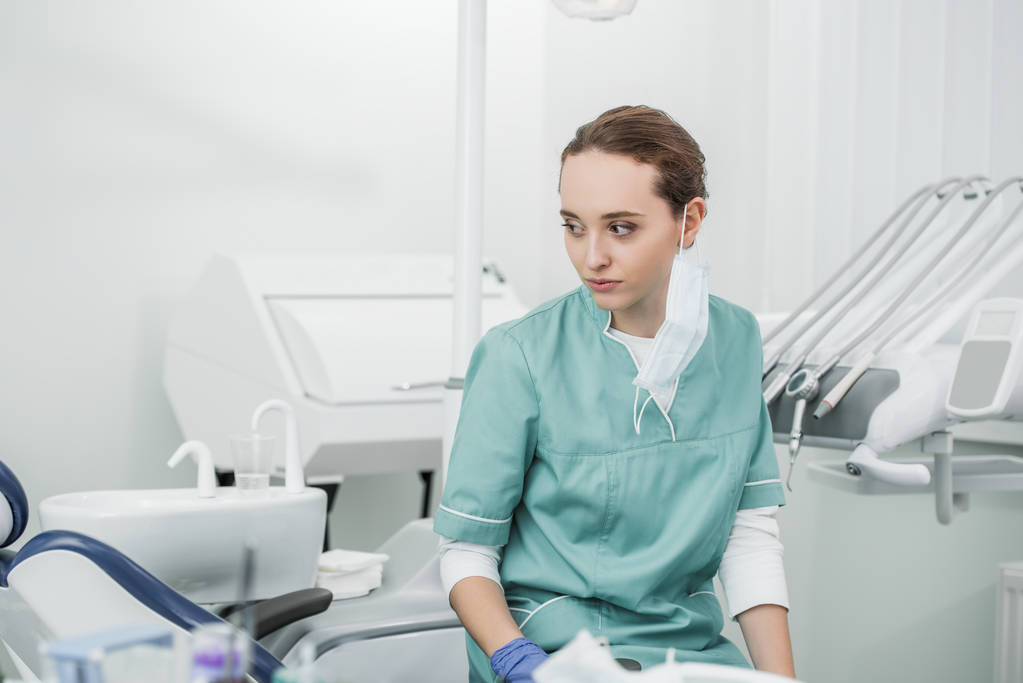 歯科医院に座って思慮深い女性歯科医の選択的 socus  - 写真・画像