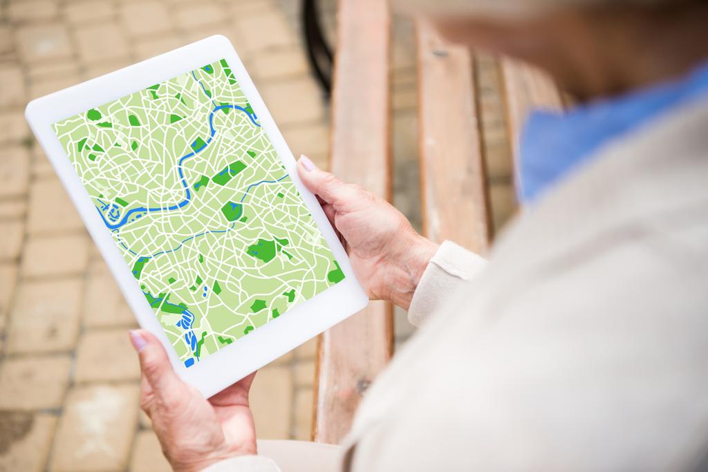 selective focus of senior woman using digital tablet with map on screen - Photo, Image