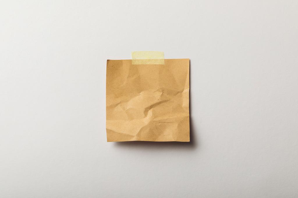 brown blank paper with sticky tape on white background - Photo, Image