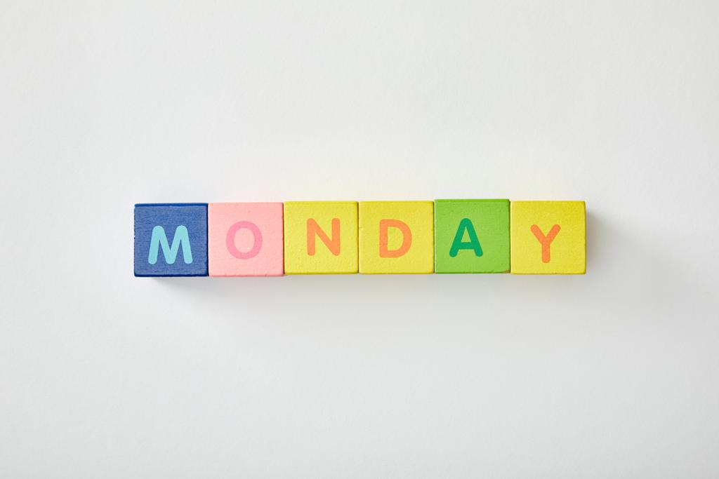 top view of monday lettering made of multicolored cubes on white background - Photo, Image