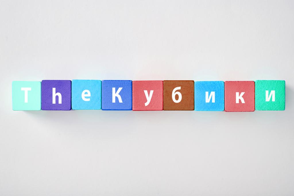 θέα πάνω από τα γράμματα που κατασκευάζονται από πολύχρωμα τετράγωνα σε γκρίζο φόντο - Φωτογραφία, εικόνα