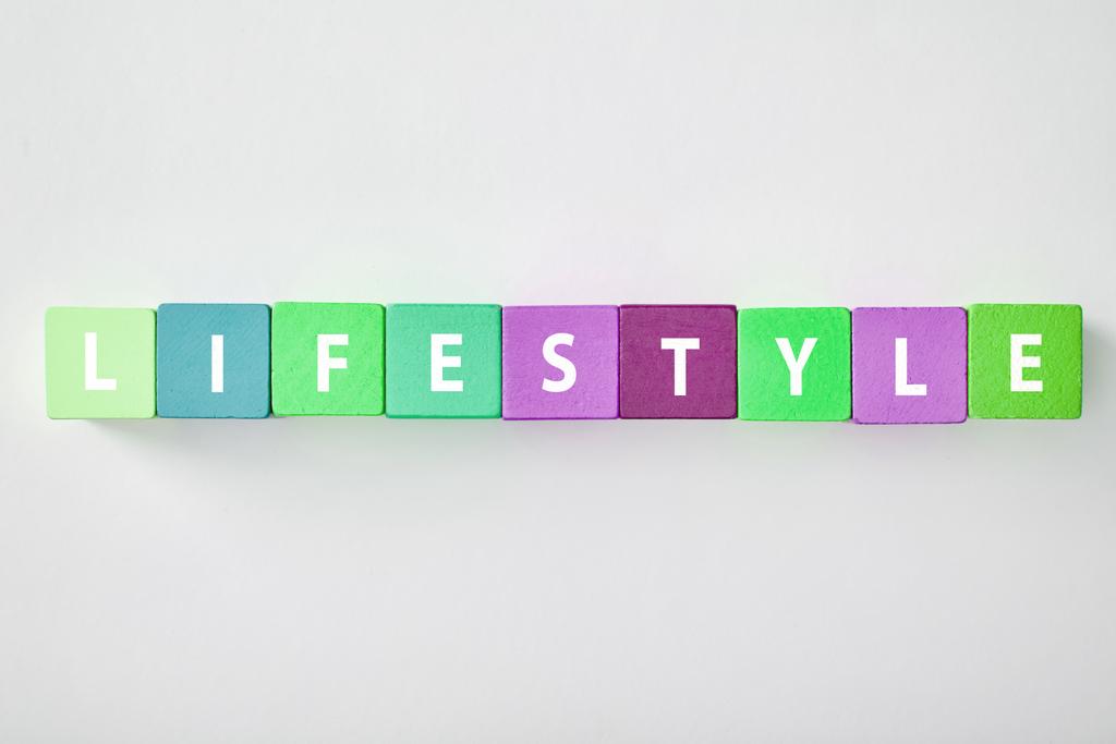 top view of lifestyle lettering made of multicolored blocks on grey background - Photo, Image