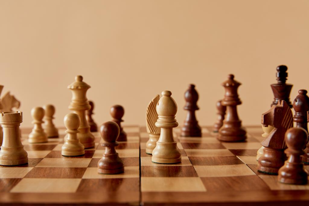 selective focus of wooden chess on board and beige background - Photo, Image