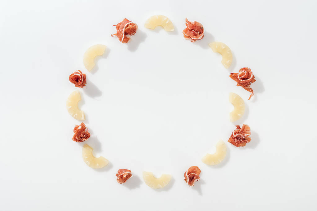 disposición plana de delicioso prosciutto cerca de piñas en rodajas sobre fondo blanco
 - Foto, Imagen