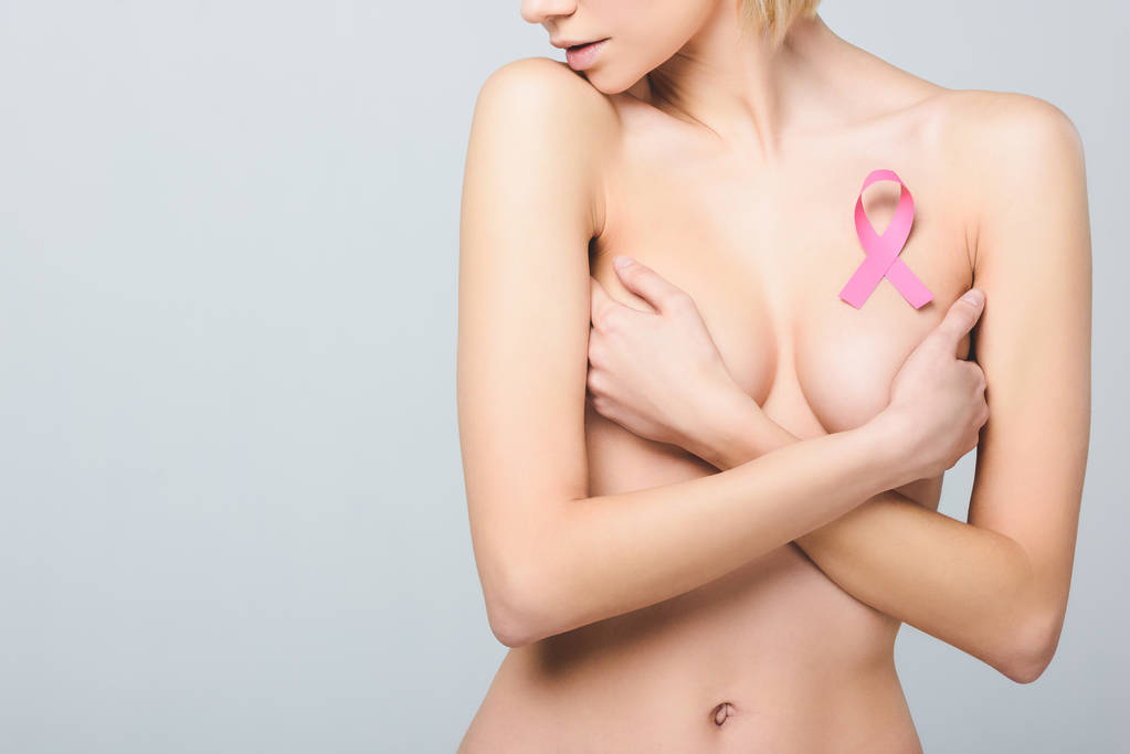 cropped view of beautiful naked girl with pink breast cancer awareness ribbon, isolated on grey - Photo, Image