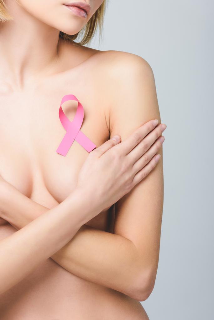 cropped view of nude girl with pink breast cancer awareness ribbon, isolated on grey - Photo, Image