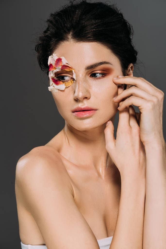 beautiful tender girl with floral petals around eye isolated on grey - Photo, Image