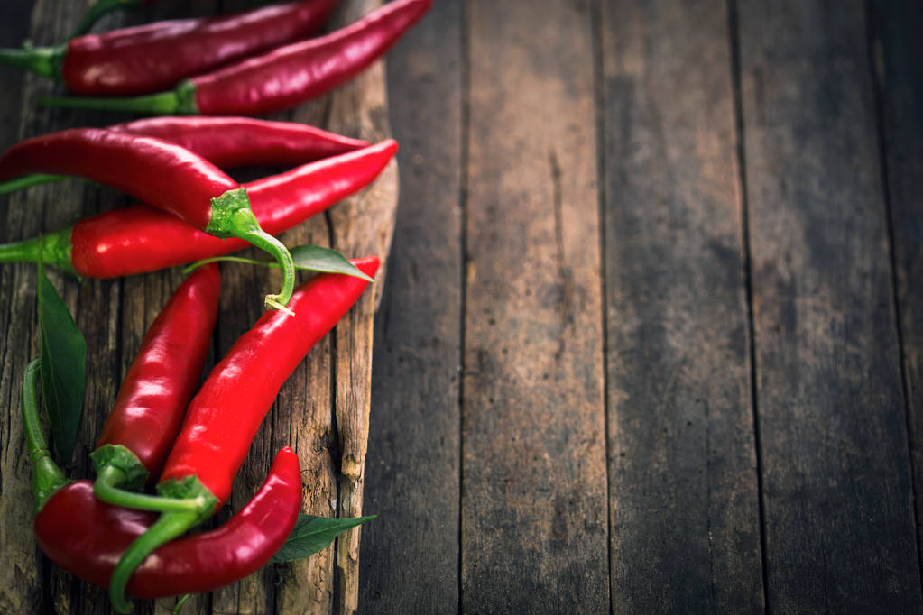 červené chilli papričky na dřevěné pozadí  - Fotografie, Obrázek