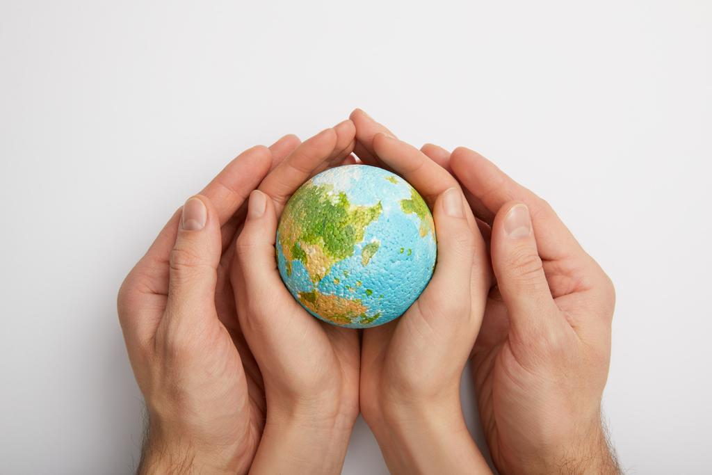top view of woman and man holding planet model on grey background, earth day concept - Photo, Image