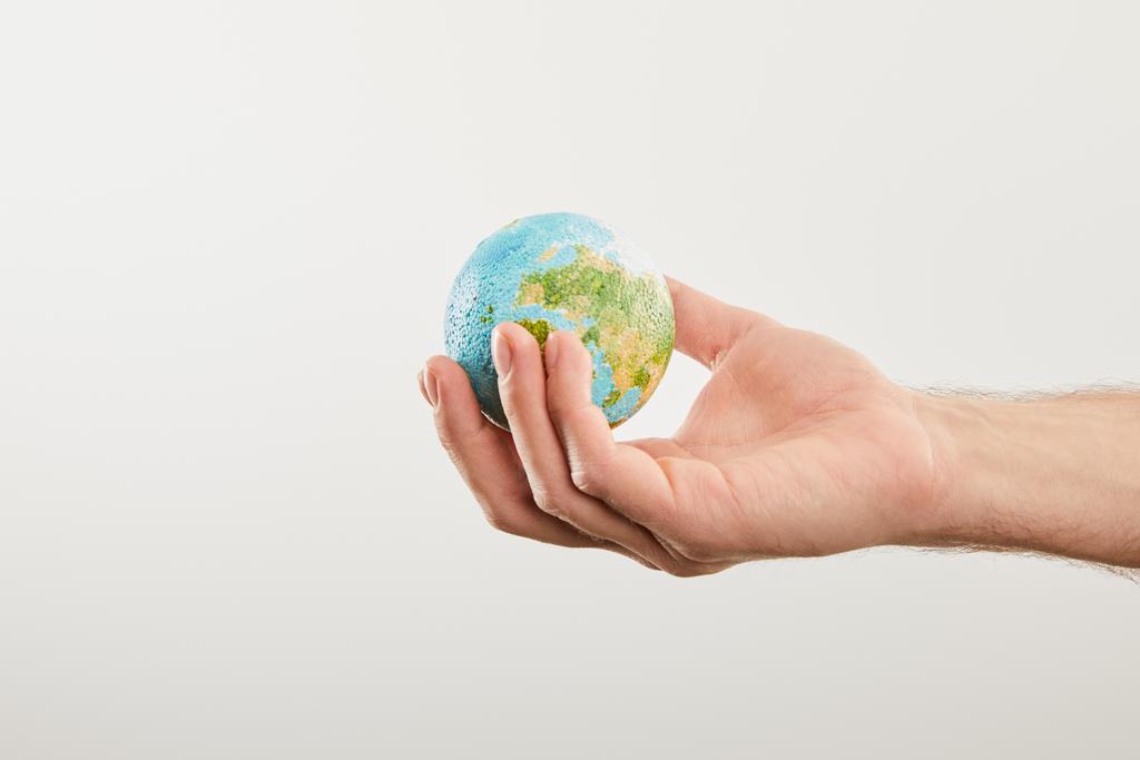 man holding planet model on grey background, earth day concept - Photo, Image