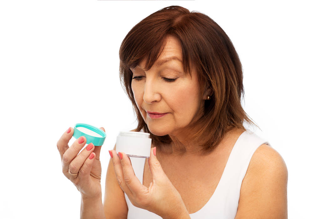 senior woman with cream jar - Photo, Image