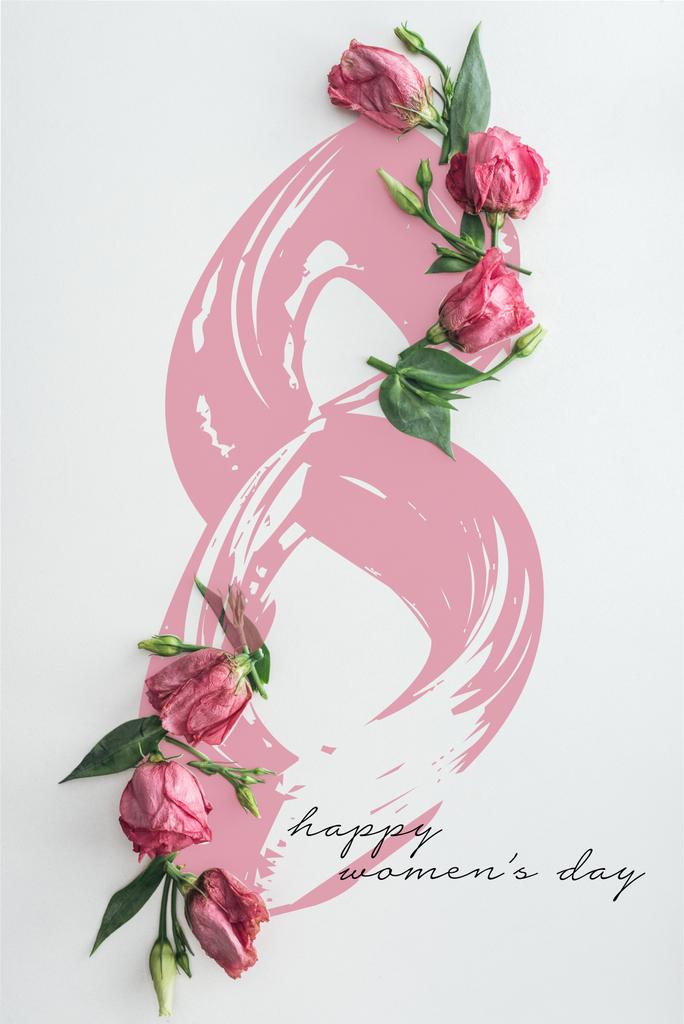 vista superior de rosas cor-de-rosa no fundo branco com letras felizes do dia das mulheres
 - Foto, Imagem