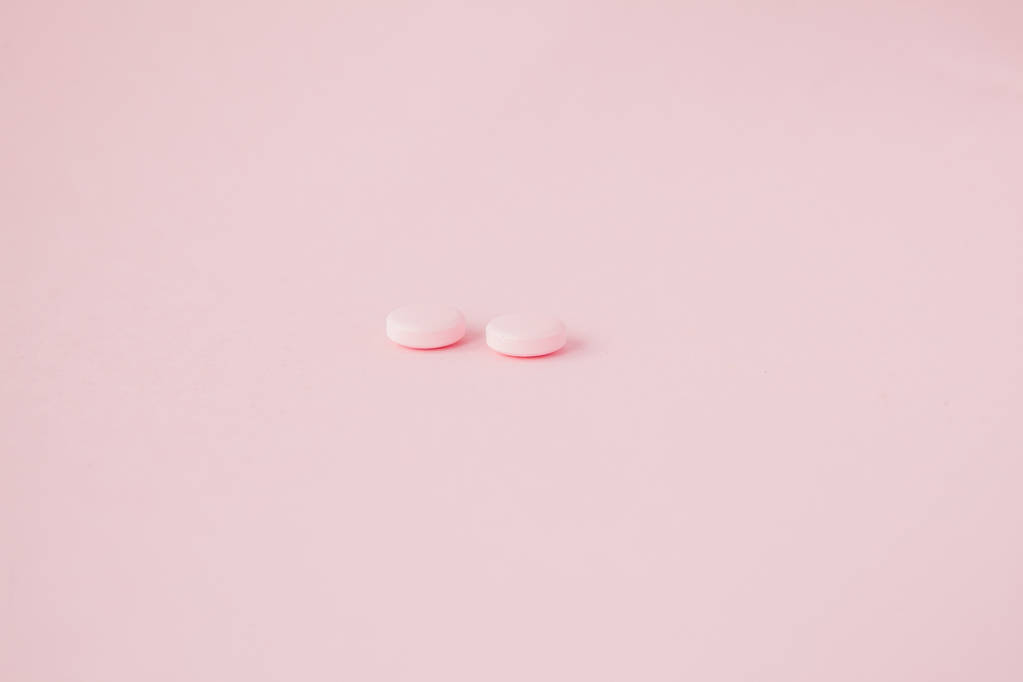 Pink pills on a pink background, copy space. - Photo, Image