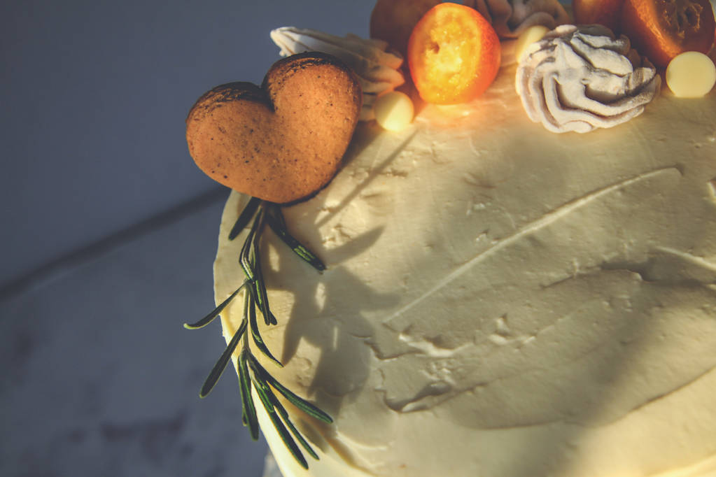 Белый торт, украшенный имбирным печеньем, зефиром, на темном фоне
 - Фото, изображение