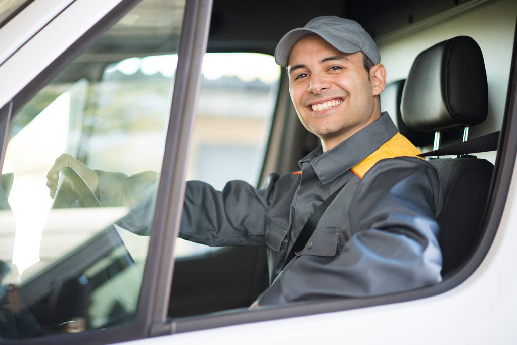 Smiling deliverer driving van - Photo, Image