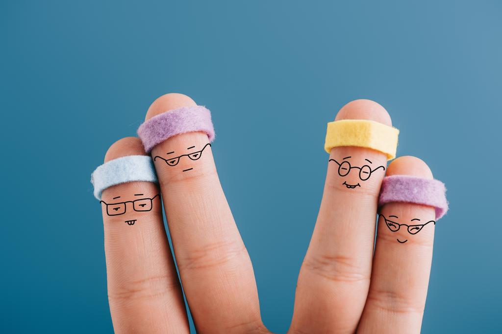 two couples of sporty fingers in eyeglasses and headbands isolated on blue - Photo, Image