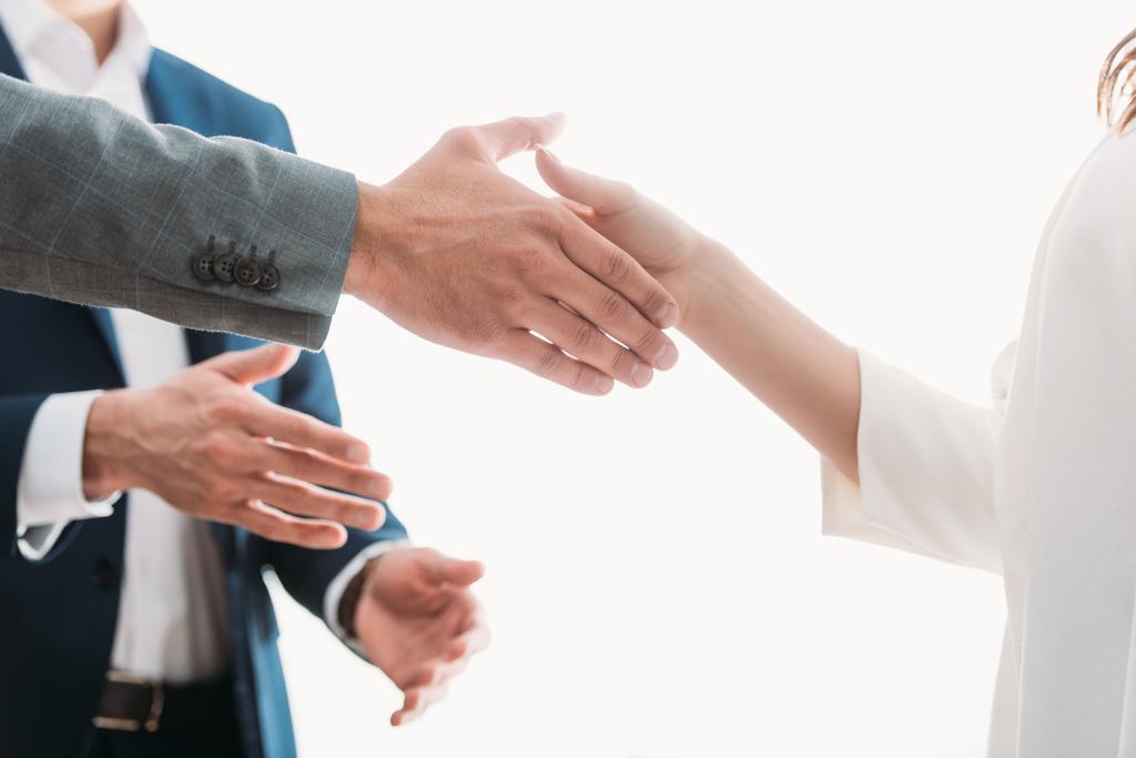 selective focus of men and woman shaking hands at office  - Photo, Image