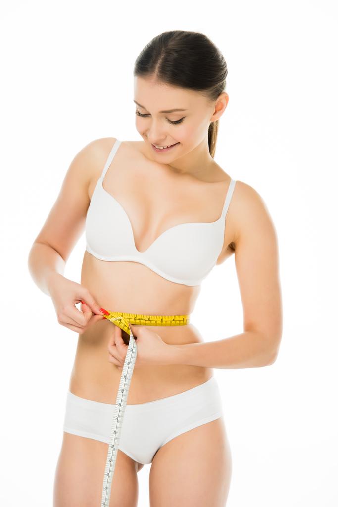 feliz sorrindo mulher magra medindo cintura com centímetro isolado no branco
 - Foto, Imagem