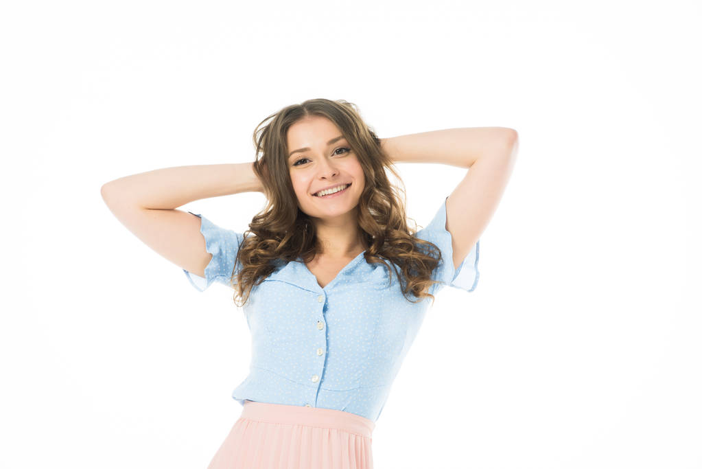 pretty smiling girl posing with hands on head isolated on white - Photo, Image