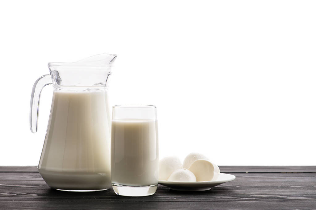 milk in a jug and glass and mozzarella cheese on a white background isolated - Photo, Image
