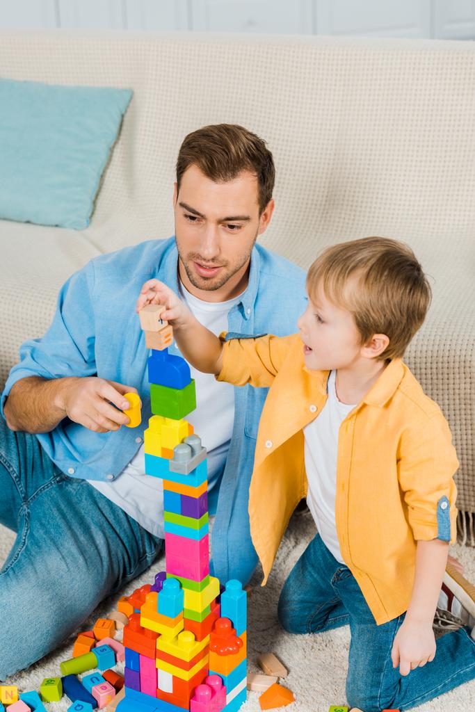 father and preschooler son playing with colorful building blocks at home - Photo, Image