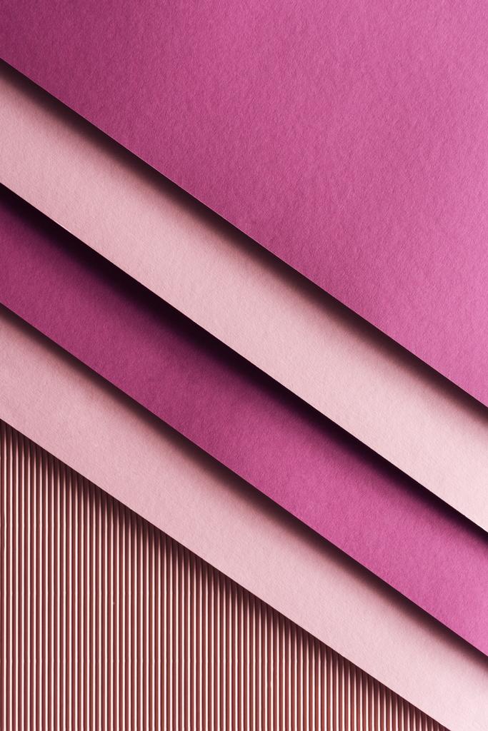 top view of pink and burgundy sheets of paper on pink background with copy space  - Photo, Image