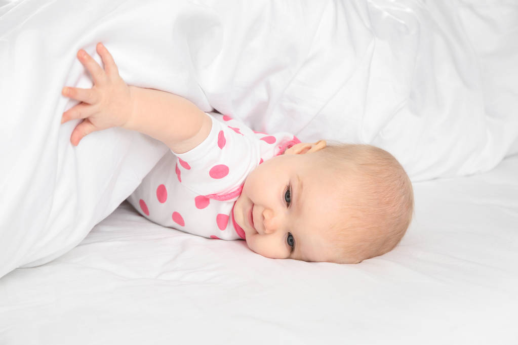 Cute baby girl in bed at home. Bedtime schedule - Photo, Image