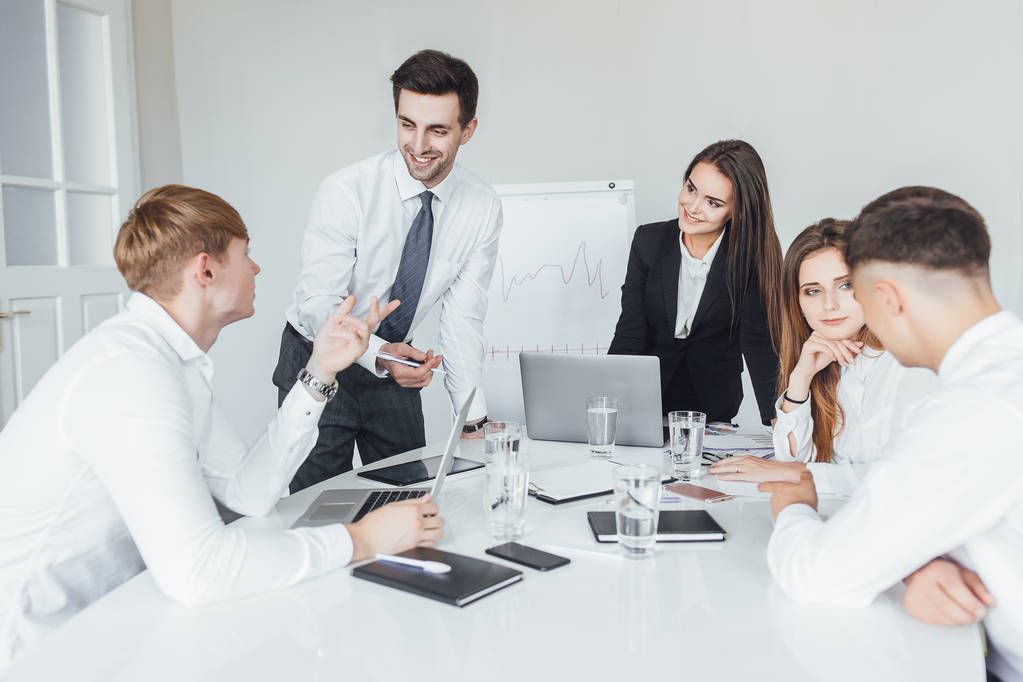 young successful business team at meeting solving business issues in modern conference room - 写真・画像