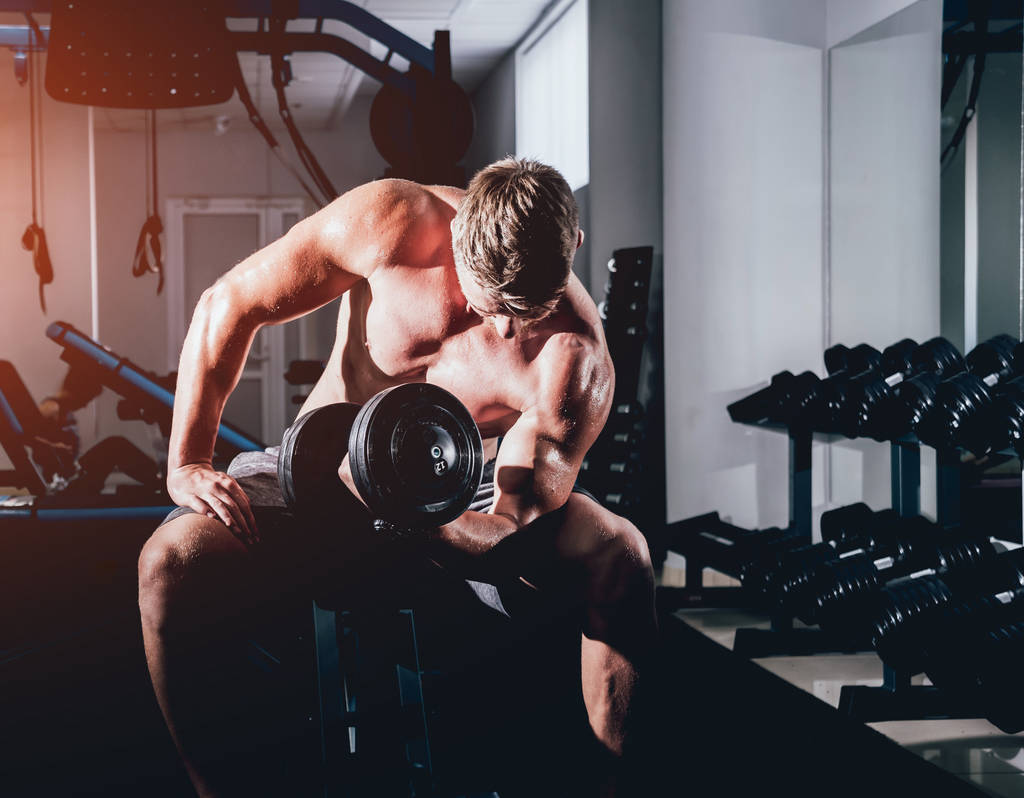 Handsome muscular man working out with dumbbells, fitness concept - Photo, Image