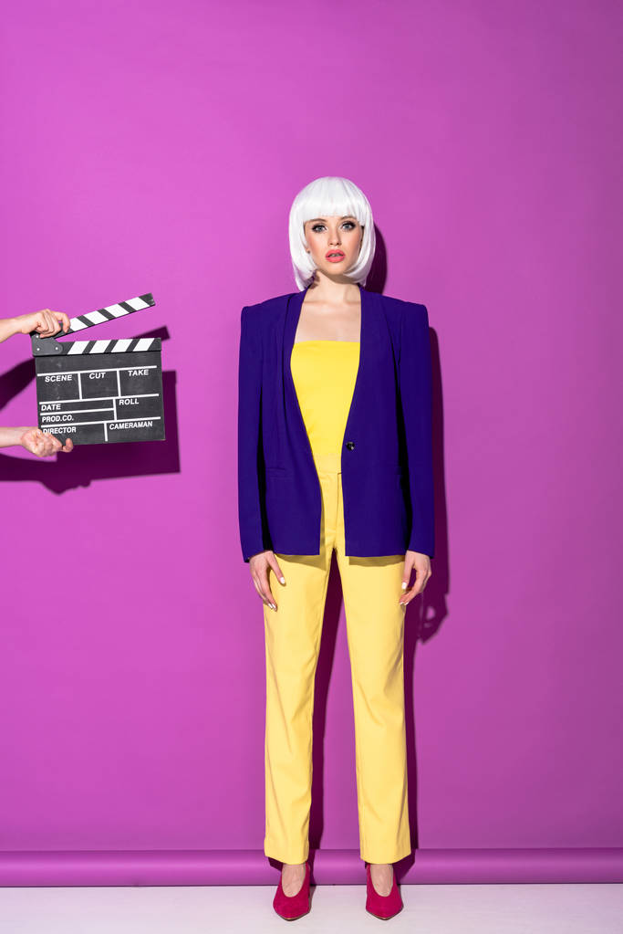 Glamorous woman in white wig standing on purple background - Photo, Image